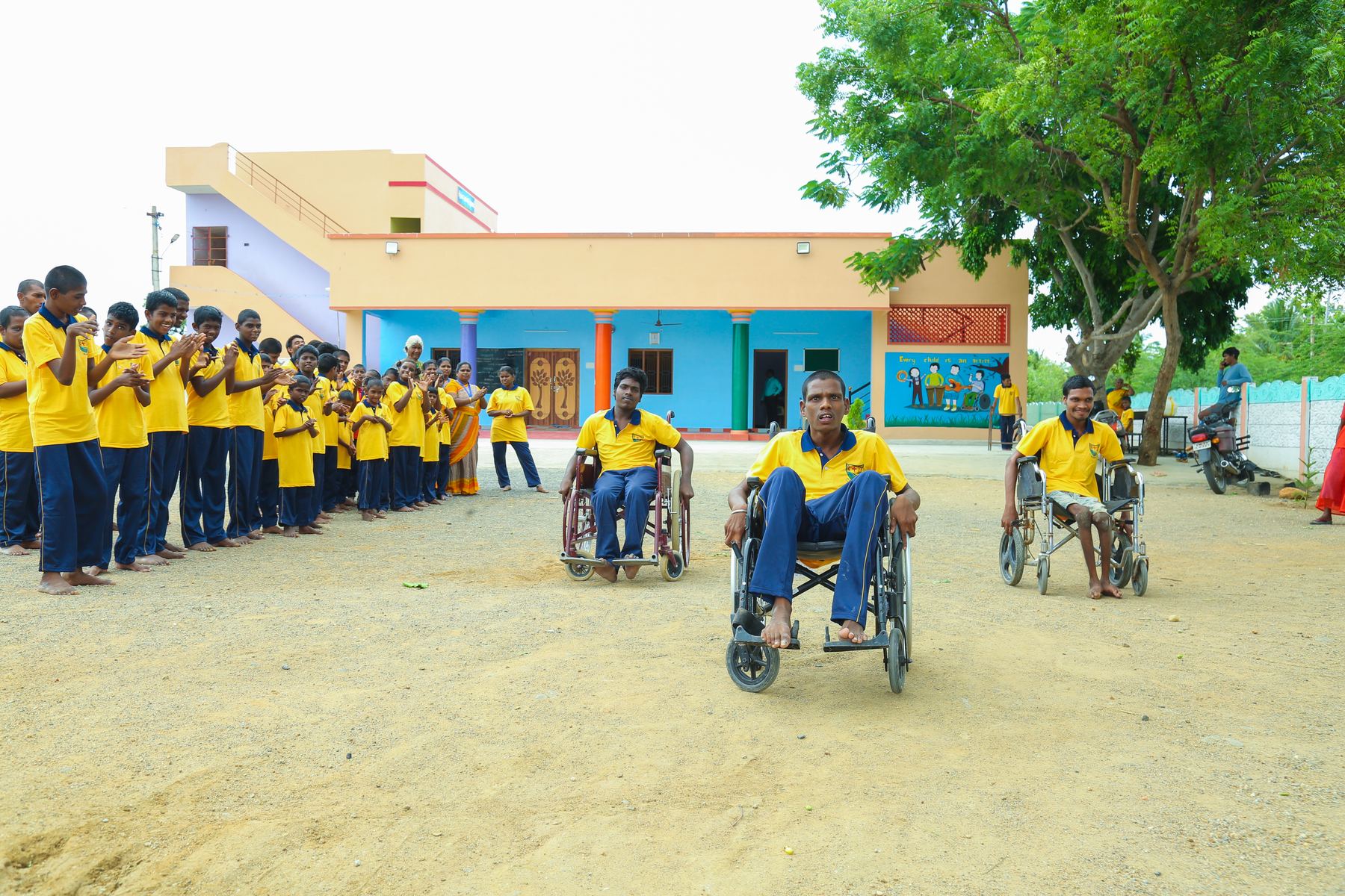 Children, including wheelchair users, gathered outside the home
