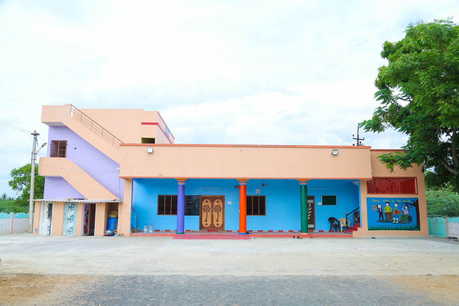 The front of the Synthika Home building with colourful pillars