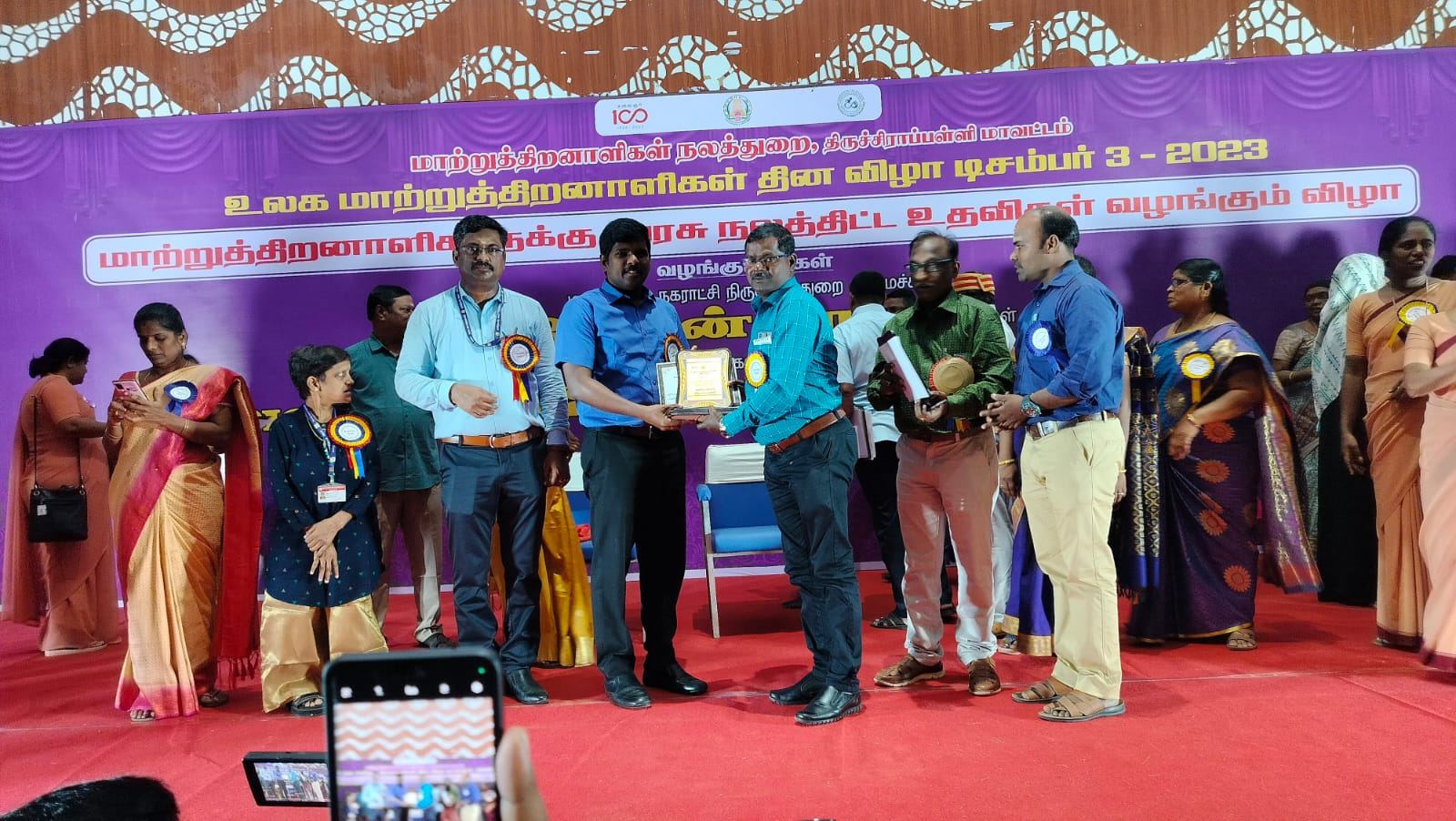 Synthika Trust representatives receiving the award on stage