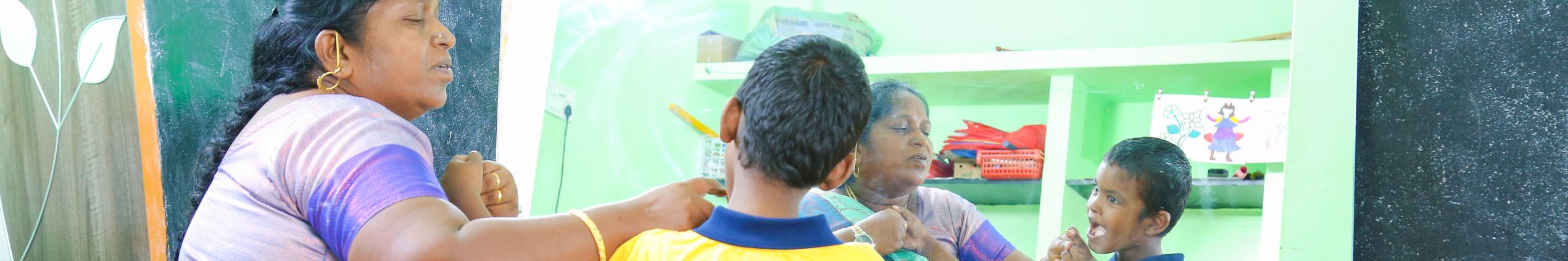 A teacher working with children at Synthika Trust